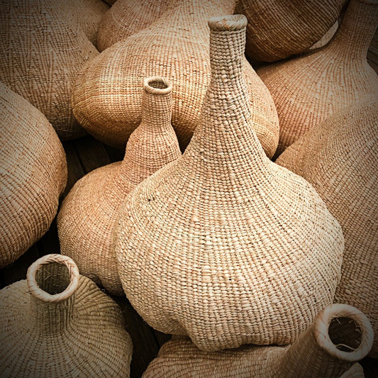 Woven garlic baskets in a pile
